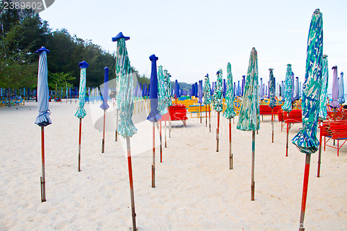 Image of Beach chair and colorful umbrella on the beach. Thailand