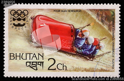 Image of Stamp printed in Bhutan shows four man bobsleigh at the Olympic Winter Games in Innsbruck