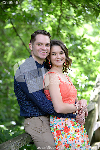 Image of Happy young couple embracing after becoming engaged