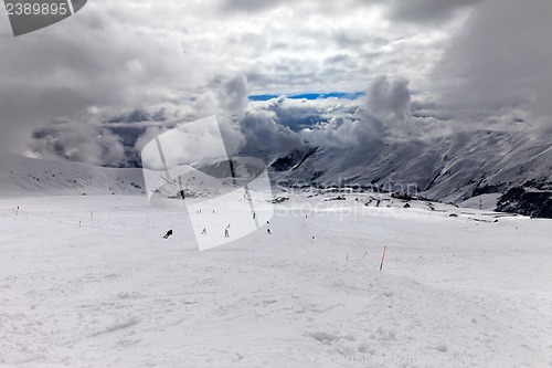 Image of Skiers on ski slope before storm