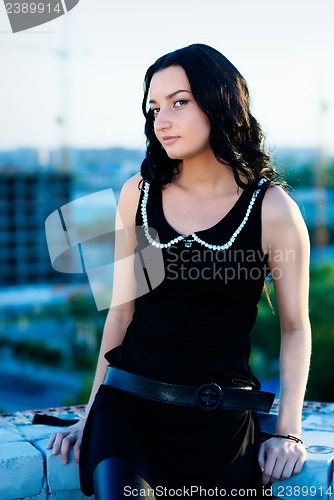 Image of Girl sitting on roof