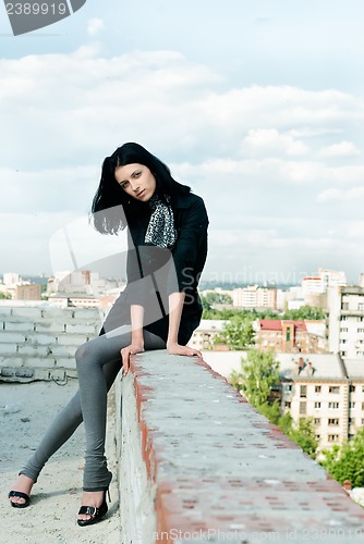 Image of Young woman on roof