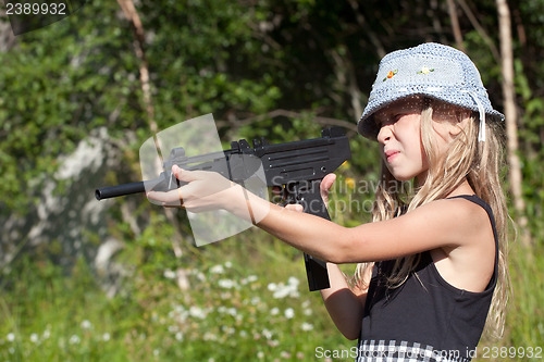 Image of little girl aiming a big gun