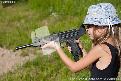 Image of little girl firing a big gun