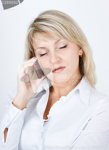 Image of The woman fallen asleep while talking on a cell phon