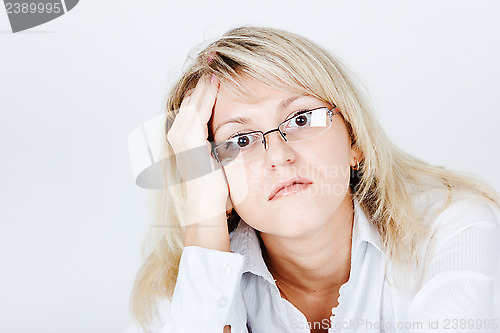 Image of Tired of attractive young blond woman in glasses