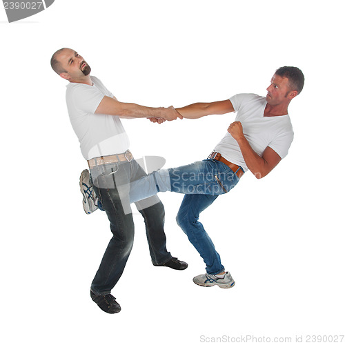 Image of Man trying to kidnap another man, selfdefense, kicking in groin