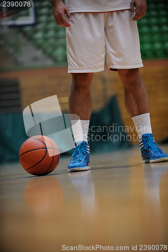 Image of basketball ball and net on black background