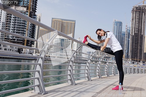 Image of Young beautiful  woman jogging  on morning