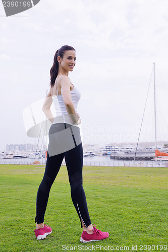 Image of Young beautiful  woman jogging  on morning