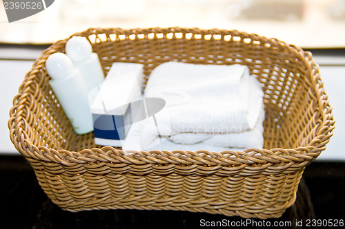 Image of bath dispensers, soap and white towel on the tray
