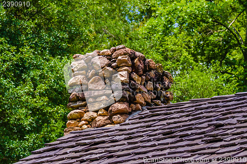 Image of Stone Chimney on Rustic Cabin