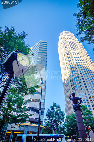 Image of standing by the clock on city intersection at charlotte downtown