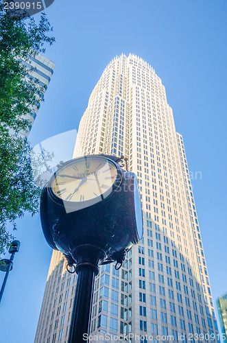 Image of standing by the clock on city intersection at charlotte downtown