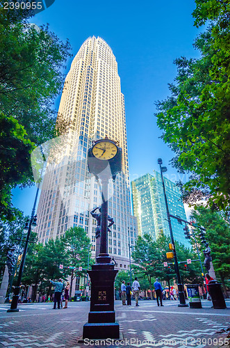 Image of standing by the clock on city intersection at charlotte downtown