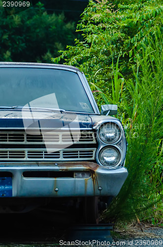 Image of old abandoned car without  a wheel