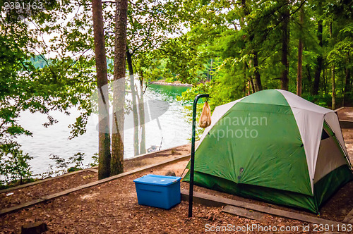 Image of tent in forest on campground by the lake