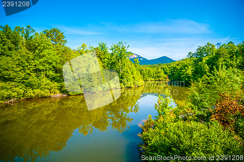 Image of tabletop mountain with nature reflections in lake