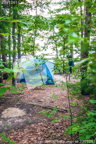 Image of tent in forest on campground by the lake