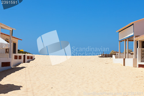 Image of Beach sand encroaching on beachfront buildings