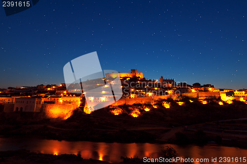Image of Walled town illuminated at night