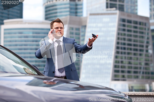 Image of Businessman near a car