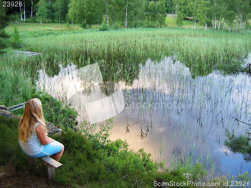 Image of Young girl by lake