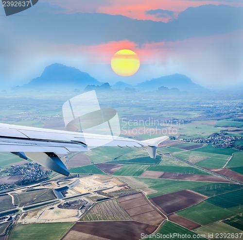 Image of aerial view through airplane porthole 