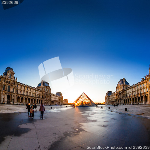 Image of Sunset shines through the glass pyramid of the Louvre museum