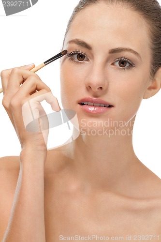 Image of doing the makeup brown eyeshadow on beautiful eyes