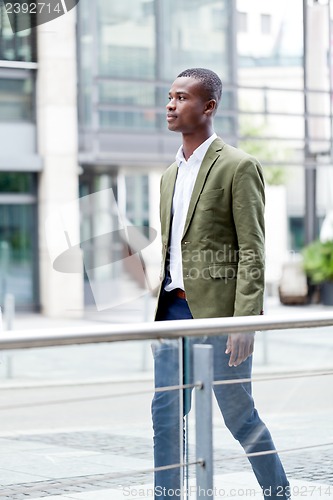 Image of young successful african business man outdoor in summer