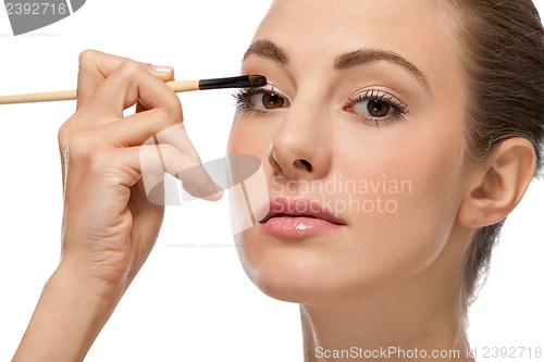 Image of doing the makeup brown eyeshadow on beautiful eyes