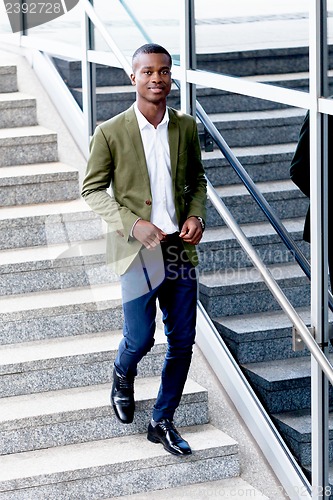 Image of young successful african business man outdoor in summer