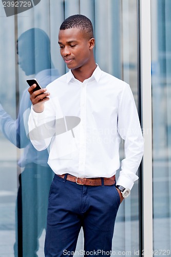 Image of young successfil african businessman with mobilephone 