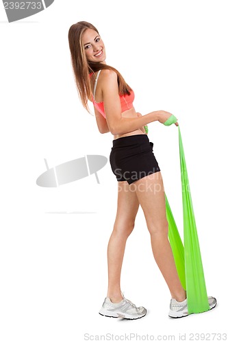 Image of athletic young woman doing workout with physio tape latex tape