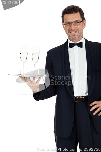 Image of adult male waiter serving two glass of champagne isolated