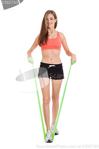 Image of athletic young woman doing workout with physio tape latex tape