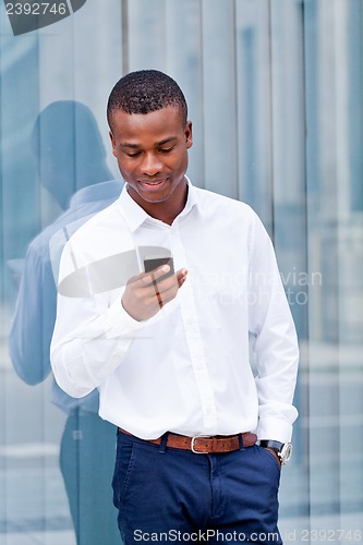 Image of young successfil african businessman with mobilephone 