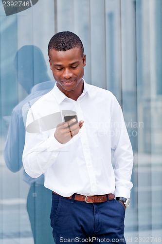 Image of young successfil african businessman with mobilephone 