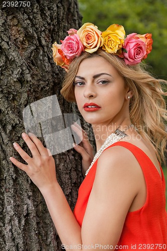 Image of beautiful woman portrait outdoor with colorful flowers