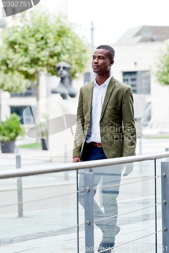 Image of young successful african business man outdoor in summer