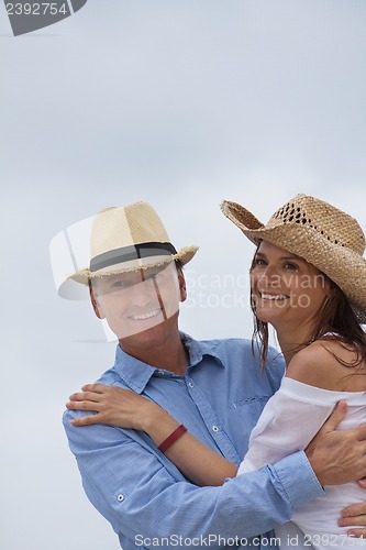 Image of happy adult couple in summertime on beach 