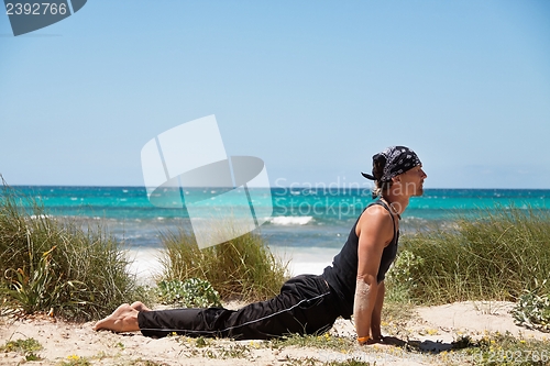 Image of adult healthy man doing pilates yoga exercise 