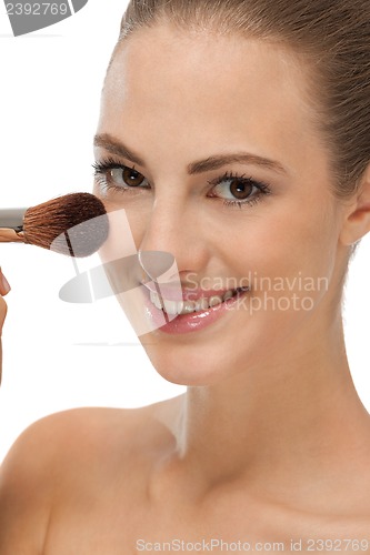 Image of apllying powder make up on face portrait