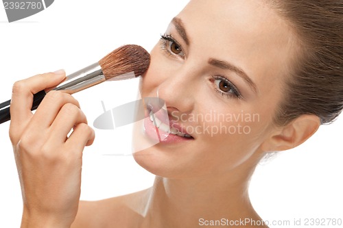 Image of apllying powder make up on face portrait