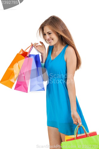 Image of attractive young woman with colorful shopping bags isolated