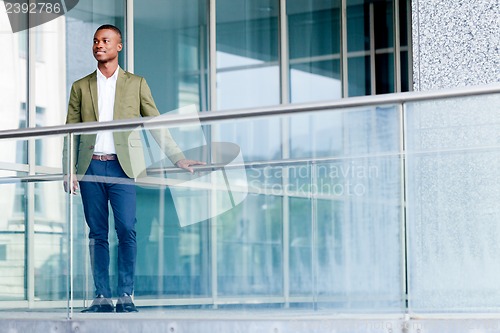 Image of young successful african business man outdoor in summer