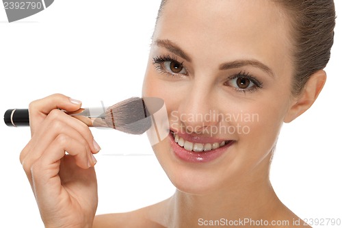 Image of apllying powder make up on face portrait