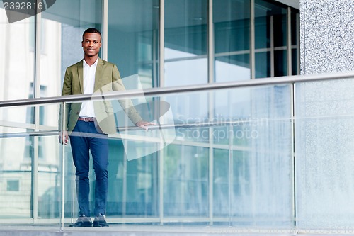 Image of young successful african business man outdoor in summer