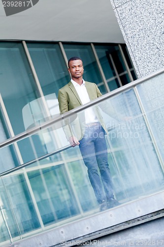Image of young successful african business man outdoor in summer